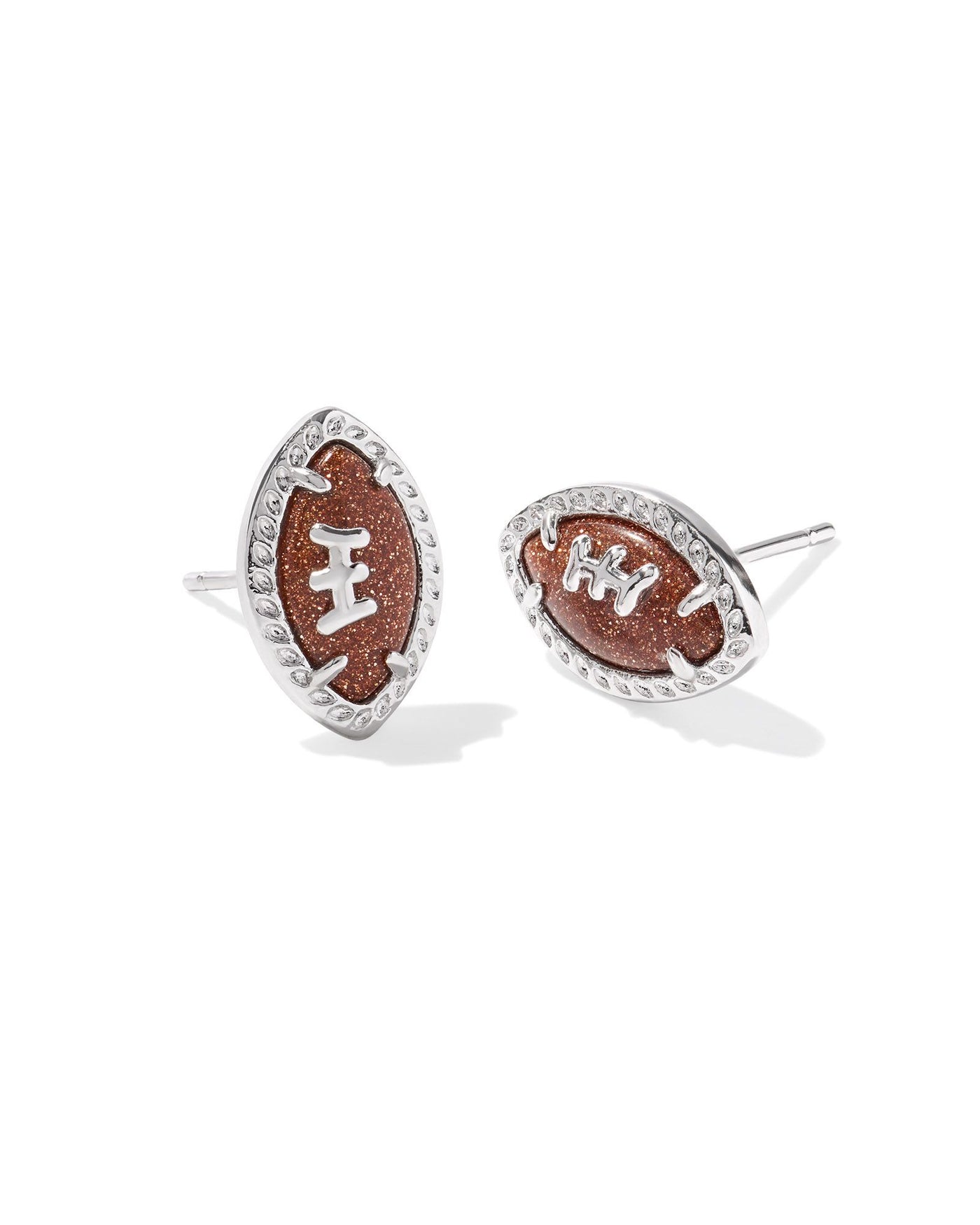 Silver framed football stud earrings.