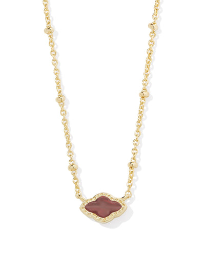 Gold satellite necklace with mini cranberry illusion gold framed pendant, closeup.