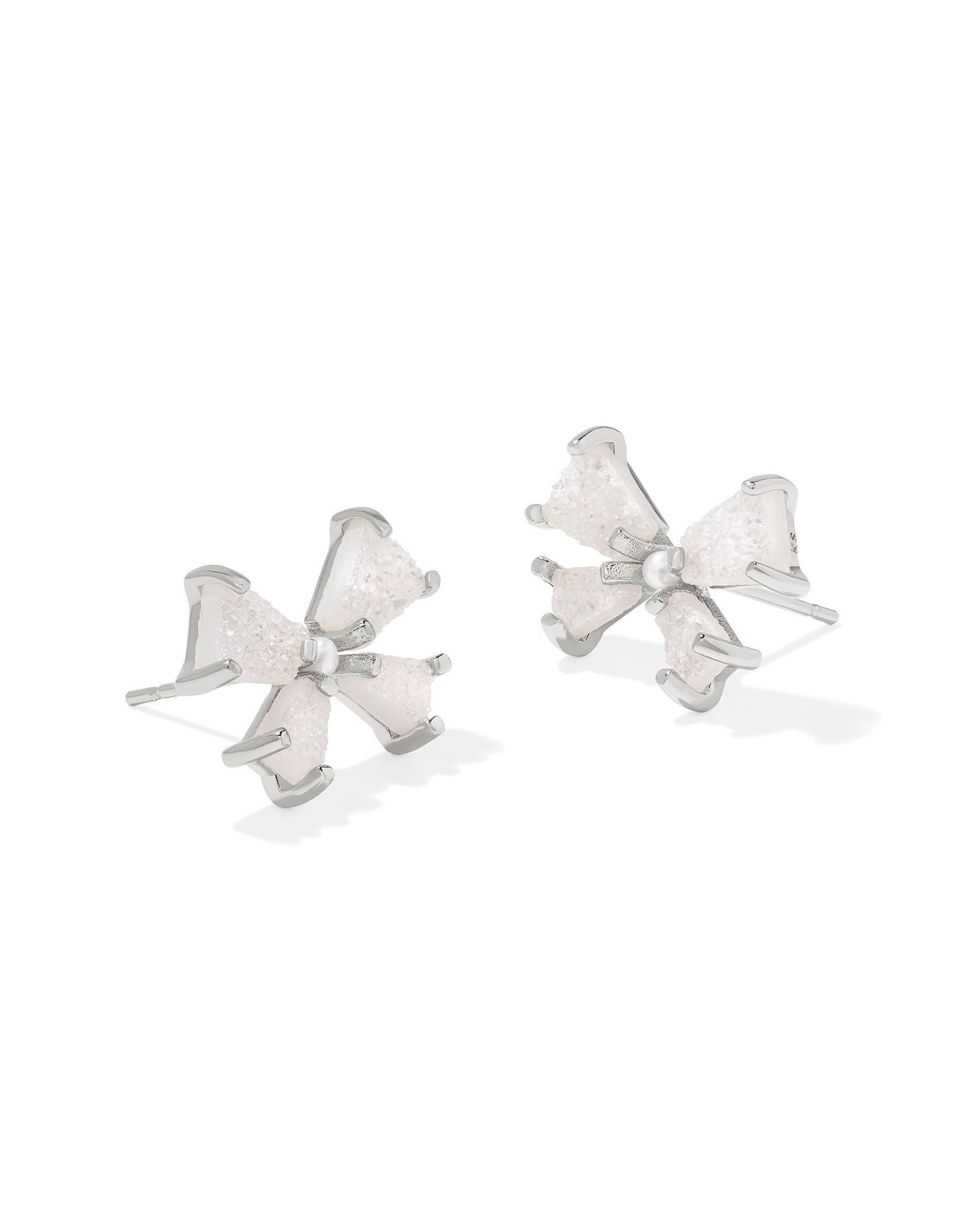 Silver iridescent bow stud earrings with pearl center.