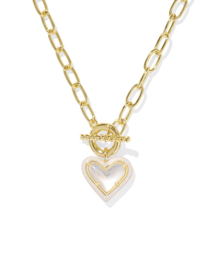 Gold link chain necklace with enamel framed ivory mother of pearl heart pendant, closeup.