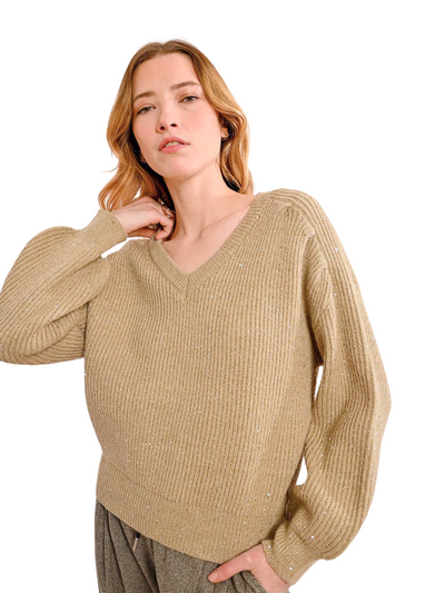 Gold v-neck sequin sweater on model, front view.