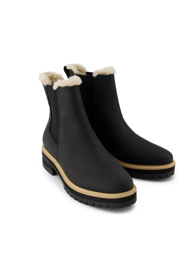 TOMS Bennet Black fur-lined chelsea boots, front/side view.