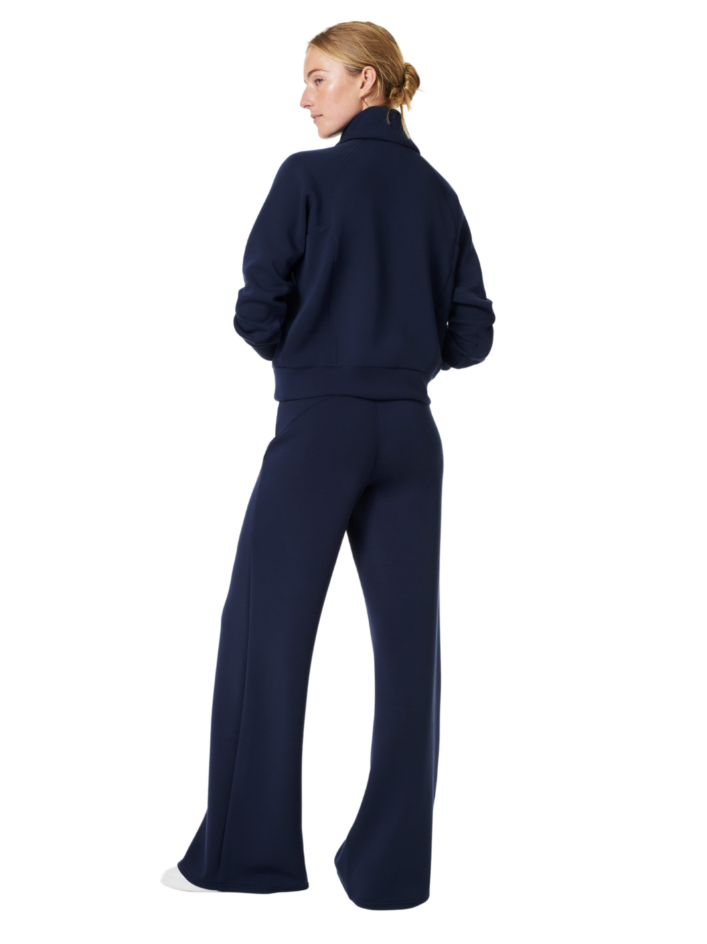 Spanx air essentials navy wide leg pants on model, back view.