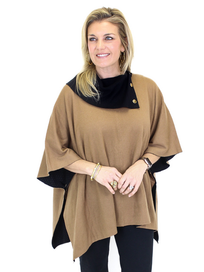 Black and tan poncho with gold buttons on model, front closeup view.