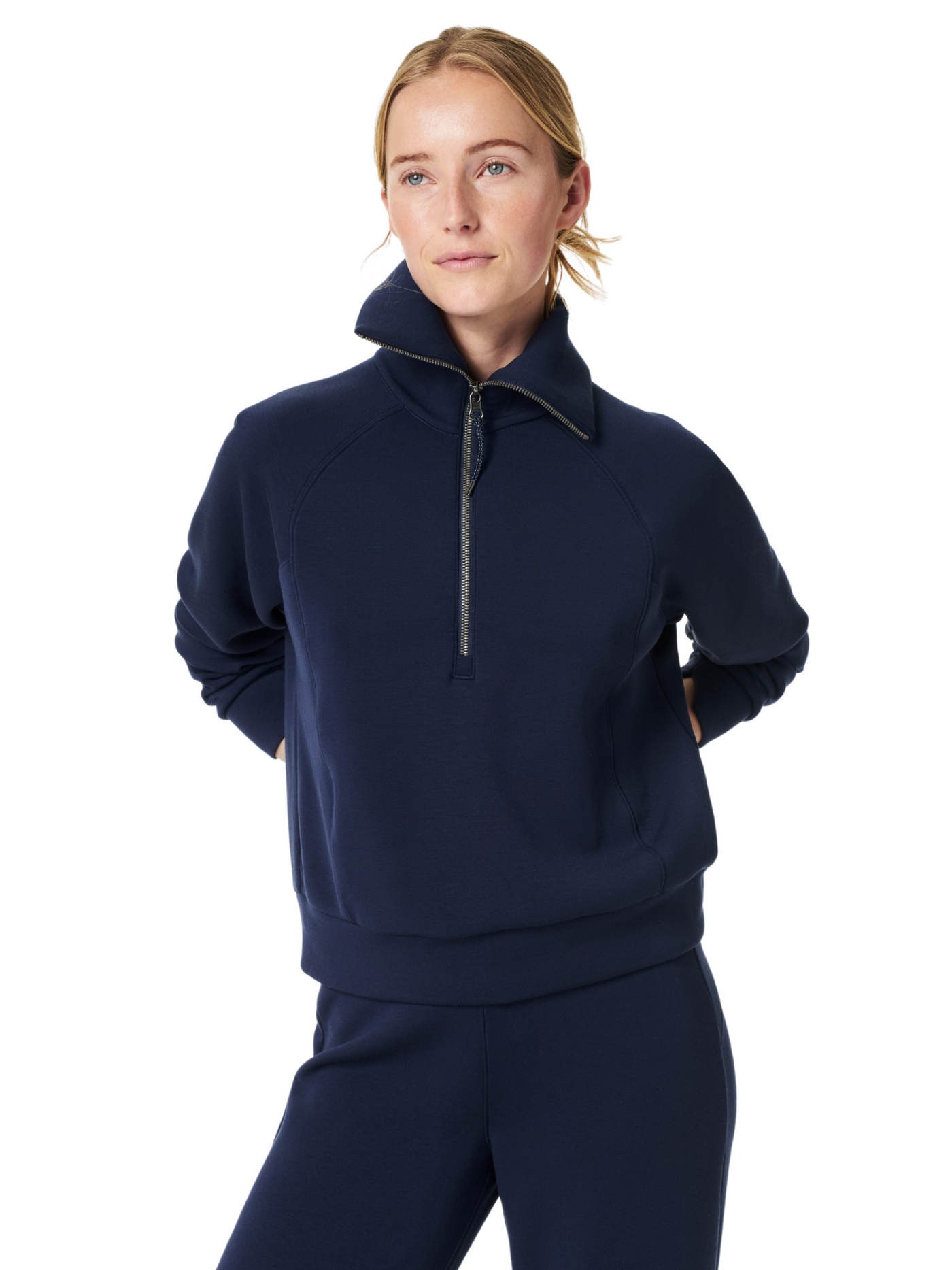 Spanx navy air essentials half-zip on model, closeup, front view.