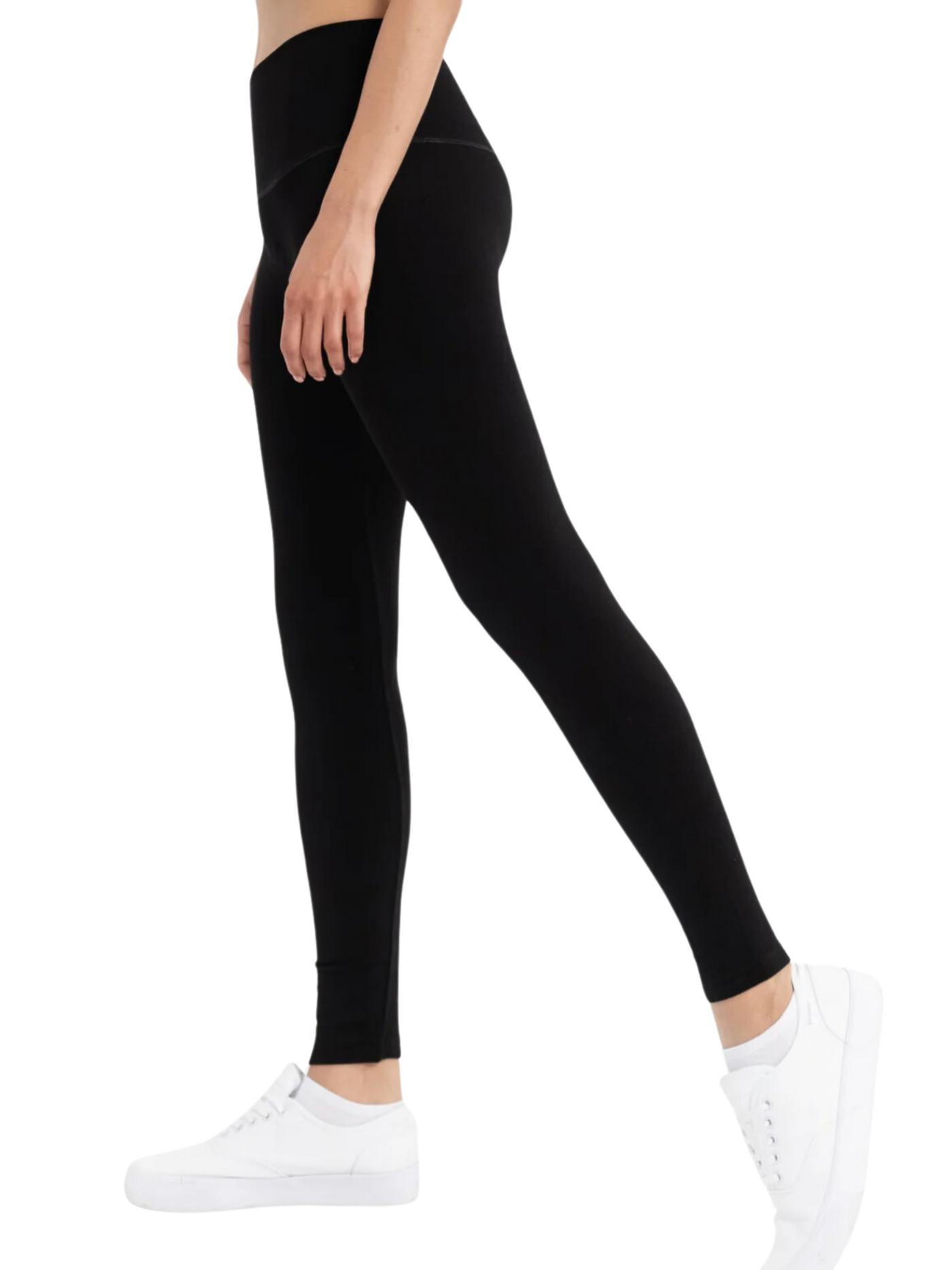 Black fleece lined leggings on model, side view.